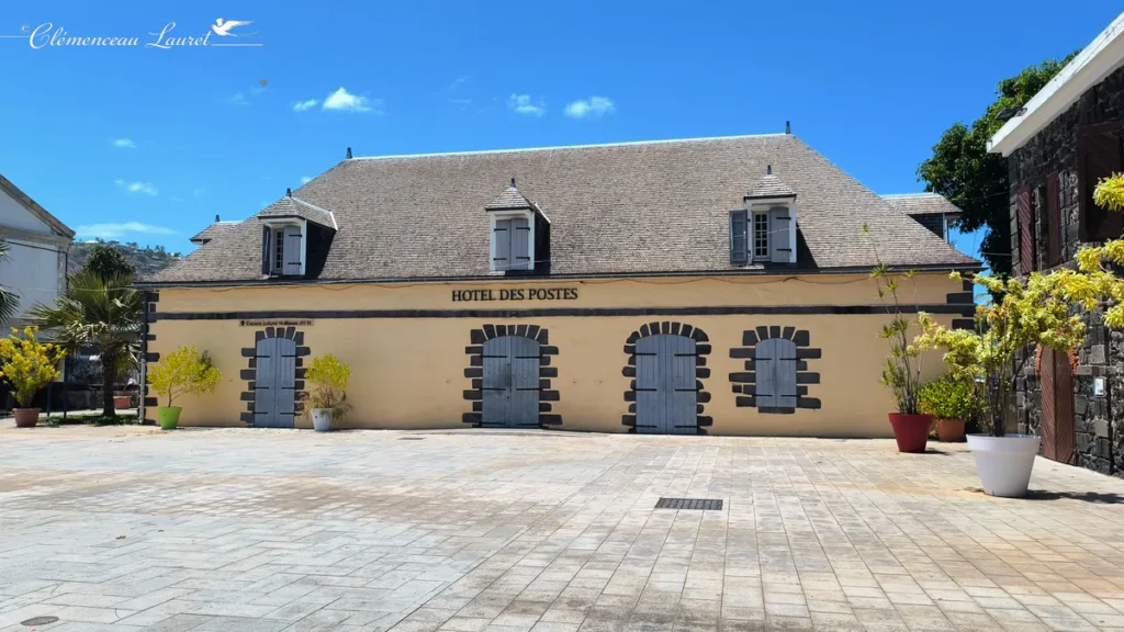 Vue d'ensemble de la place pavée devant l'Hôtel des Postes à Saint-Leu